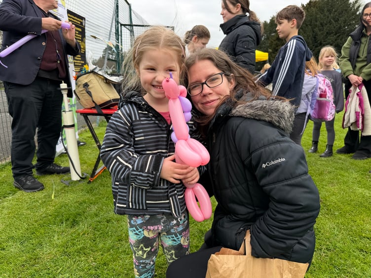 Cassie and Amanda Loveridge pleased with a unicorn balloon from Tony Balloonman