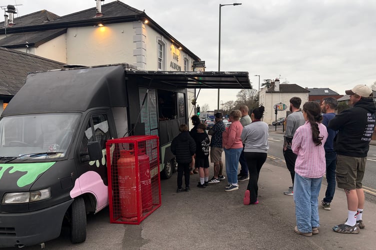 Crowd gathers outside the Hungry Boys food truck for their Wing Wednesday at the Albion Tavern