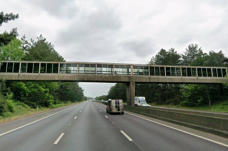 The Scott Mills bridge. // The Scott Mills bridge plaque has been removed following the star's sacking from the BBC. The plaque for the "Scott Mills Bridge" at Fleet Services on the M3 motorway was officially unveiled on March 16, 2016 - after a light hearted campaign on his radio show to get the bridge named after him. But, 10 years on, it has now been removed following the star's sudden sacking from his hit Radio 2 show. A driver, who spoke to Sell Us Your Story, stopped off at the service station today (02/04) when he noticed the plaque no longer bore the star's name.  