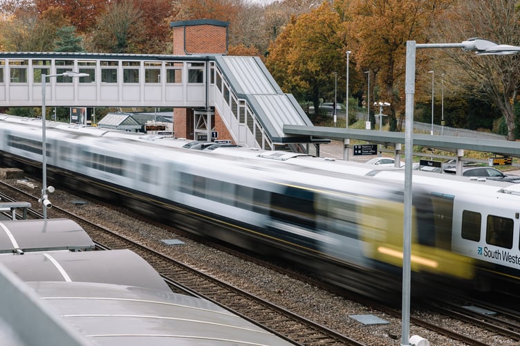 A South Western Railway train passes through Fleet station.