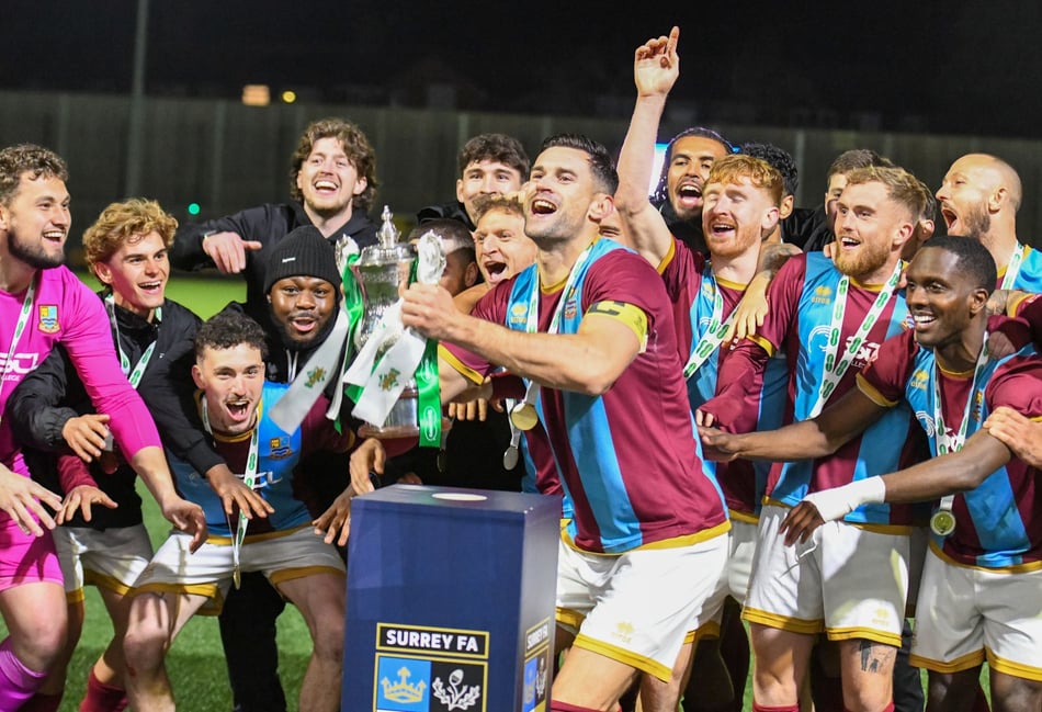 <p>Farnham Town captain Ryan Kinnane lifts the Surrey Senior Cup</p>