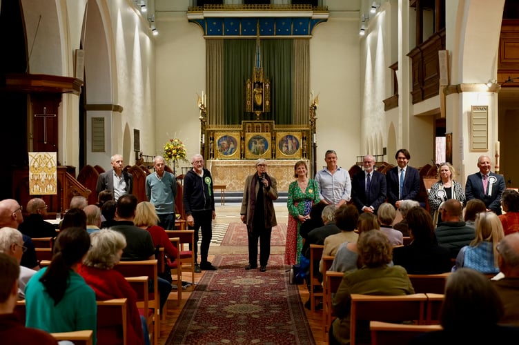 Revd Sandy Clarke introduces the candidates at the South Farnham local elections hustings.