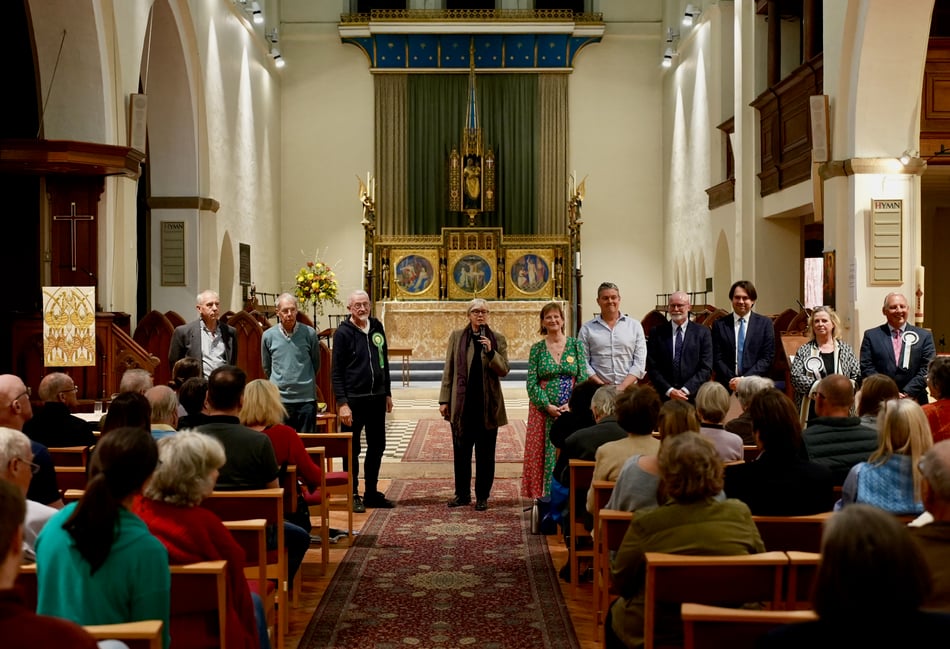 <p>Revd Sandy Clarke introduces the candidates at the South Farnham local elections hustings.</p>