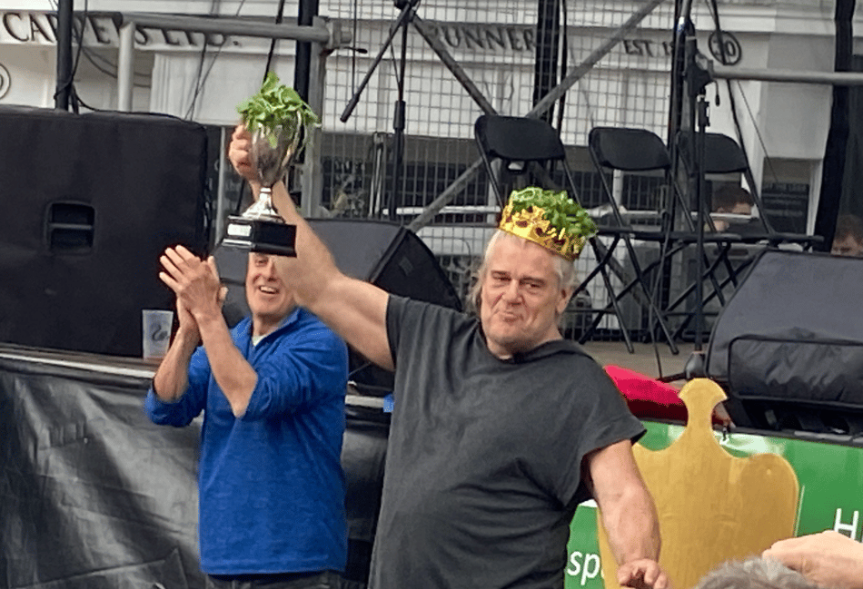 <p>Celebrity chef Phil Vickery leads the applause as Glenn Walsh from Bishop's Sutton lifts the World Watercress Eating Championship trophy for the 18th time.</p>