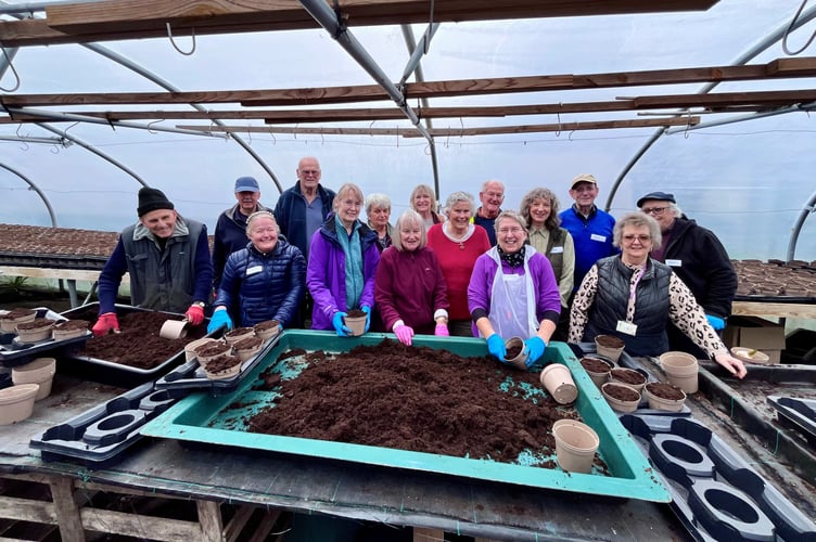 Farnham volunteers filling pots.