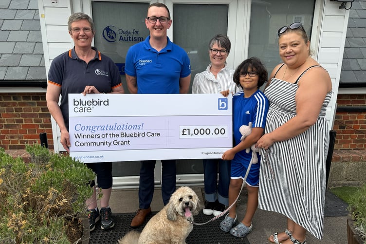 Bluebird Care presents its £1,000 community grant to Dogs for Autism, alongside Jon, his mother Kelly and his assistance dog Casper, June 5th 2026.