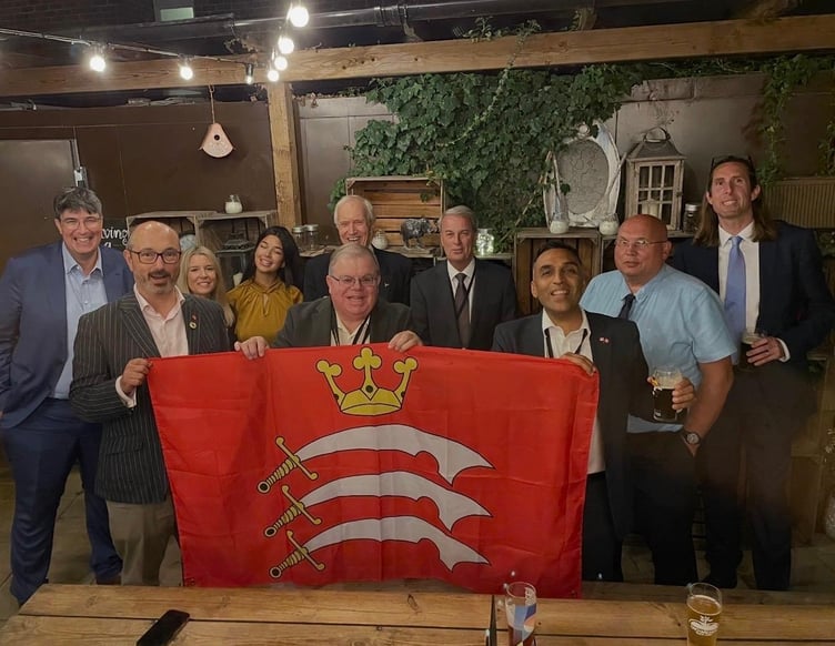 Cllr Harry Bopari with fellow councillors holding a Middlesex flag.