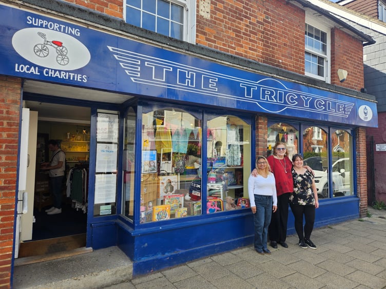 From left: Sonia Khawar, Tessa Thonett and Joanna Wakeford in front of The Tricycle charity shop. Tessa's husband Markus Thonett created the sign.